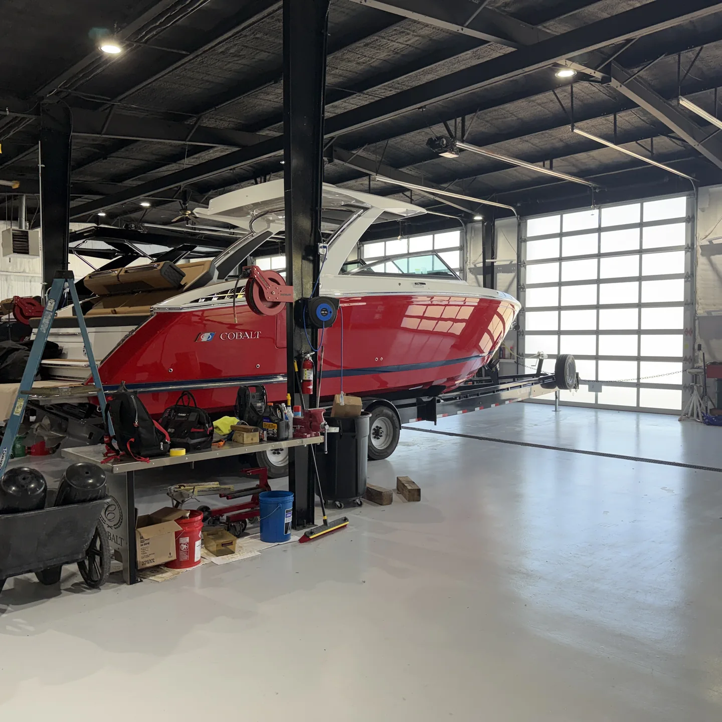 Red Cobalt boat on a trailer inside a Village Marina service bay
